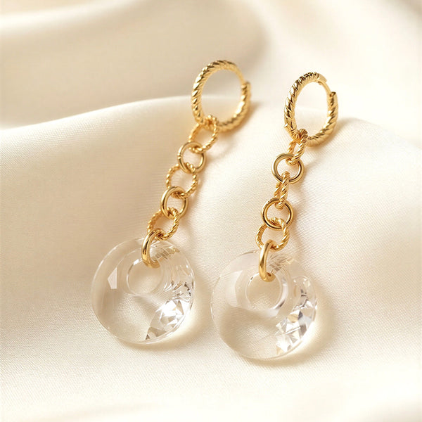 Clear Swarovski Victory crystal long-drop earrings with 18mm crystals and gold-plated sterling silver huggie hoops by Marj Silver.