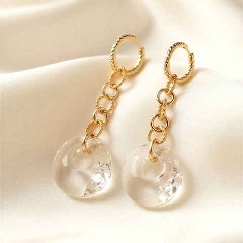 Clear Swarovski Victory crystal long-drop earrings with 18mm crystals and gold-plated sterling silver huggie hoops by Marj Silver.
