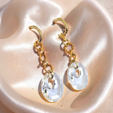 Clear Swarovski Victory crystal long-drop earrings with 18mm crystals and gold-plated sterling silver huggie hoops by Marj Silver.