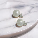 Hand-carved freshwater pearl earrings with rose-like spiral design set on sterling silver studs