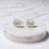 Hand-carved freshwater pearl earrings with rose-like spiral design set on sterling silver studs