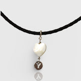 Necklace with a heart-shaped pendant and 'Y' charm on a white background