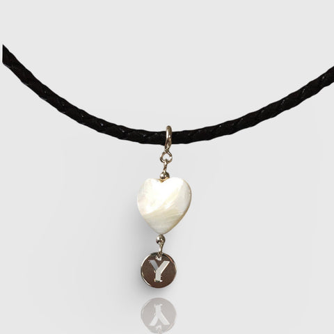 Necklace with a heart-shaped pendant and 'Y' charm on a white background