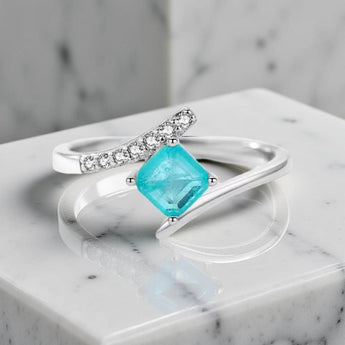Sterling silver ring with square green blue tourmaline gemstone showing ocean-like hues