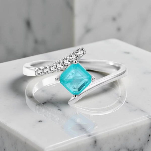 Sterling silver ring with square green blue tourmaline gemstone showing ocean-like hues