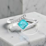 Sterling silver ring with square green blue tourmaline gemstone showing ocean-like hues