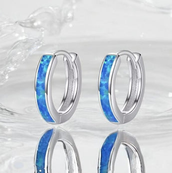 Sterling silver blue opal huggie earrings with shimmering October birthstone
