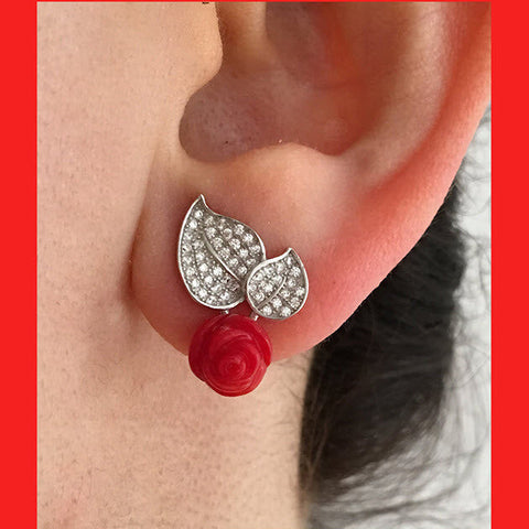 A sterling silver leaf-shaped stud earring with a rose-shaped coral attachment, set with cubic zirconia.