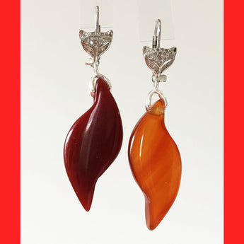 A pair of sterling silver fox earrings with an 'S' shaped agate attachment